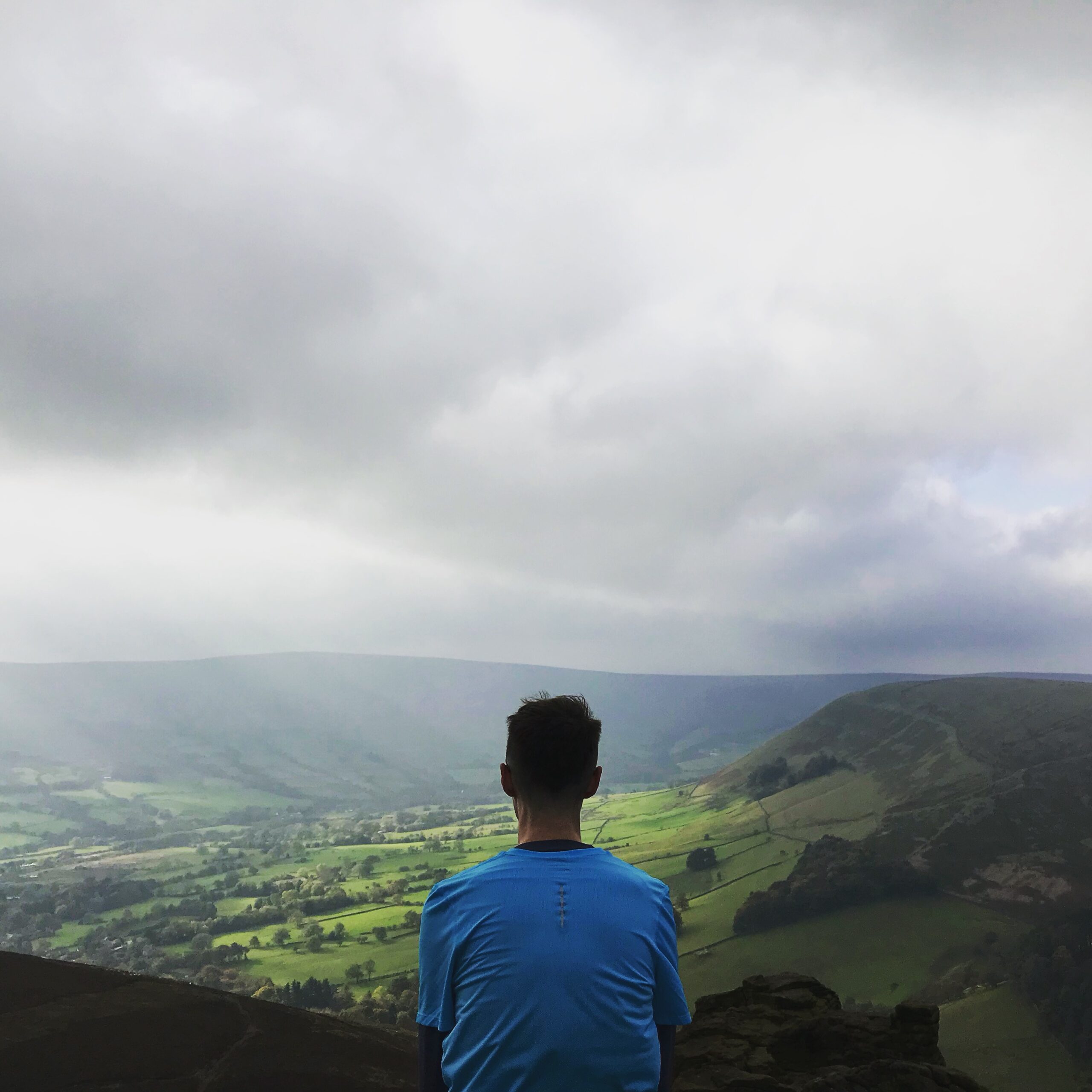 Runner sat on a rocky outcrop on Kinder Moor